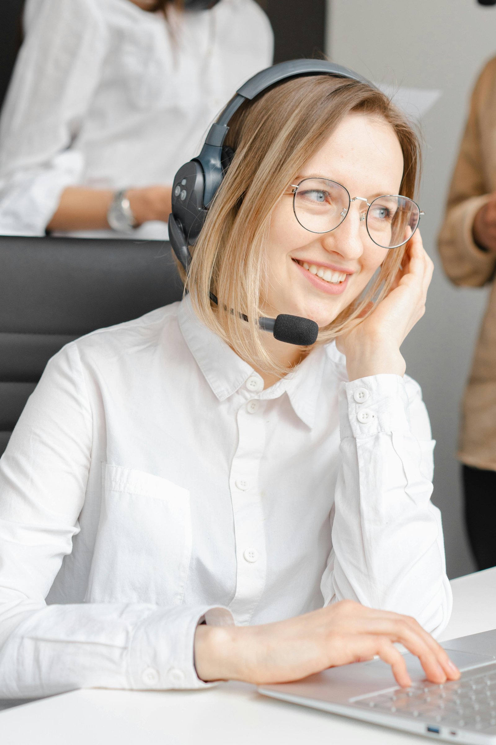 Professional woman in headset offering customer support at a call center.